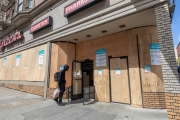 An pedestrian enters the local Walgreens covered with  plywood  to discourage looting in San Francisco on March 31, 2020 .
Millions of San Francisco Bay Area  residents were ordered to stay home for the third week to slow the spread of the coronavirus as part of a lockdown effort.