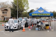 Firefighters and paramedics assist people at a first-of-its-kind COVID-19 testing center in Hayward, CA, on March 23, 2020.  The free test facility opened to  to the public this morning regardless of where the patients live or their immigration status. 
The entire state of California is on a shelter-in-place status ordered by the governor to slow the spread of the COVID-19 disease.