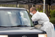 A Paramedic checks the temperature of driver at a first-of-its-kind COVID-19 testing center in Hayward, CA, on March 23, 2020.  If the fever is above 100.4 degrees Fahrenheit, they will be tested for the coronavirus. 
The free test facility opened to  to the public this morning regardless of where the patients live or their immigration status. 
The entire state of California is on a shelter-in-place status ordered by the governor to slow the spread of the COVID-19 disease.