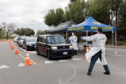 Firefighters and paramedics assist people at a first-of-its-kind COVID-19 testing center in Hayward, CA, on March 23, 2020.  The free test facility opened to  to the public this morning regardless of where the patients live or their immigration status. 
The entire state of California is on a shelter-in-place status ordered by the governor to slow the spread of the COVID-19 disease.