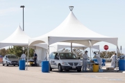 Health care workers assist people at a COVID-19 testing drive-through center in Hayward, CA, on April 15, 2020.  Hayward firefighters with cooperation with Hayward Police and paramedics set up the center to take pressure off hospital emergency rooms. It is free and available to anyone who show symptoms such as fever.