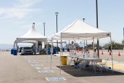 Health care workers assist people at a COVID-19 testing drive-through center in Hayward, CA, on April 15, 2020.  Hayward firefighters with cooperation with Hayward Police and paramedics set up the center to take pressure off hospital emergency rooms. It is free and available to anyone who show symptoms such as fever.