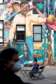 A man wearing a mask waits for his turn to be tested inside a school in the heavily Latino Mission District of San Francisco, CA, on April 25, 2020. Doctors and volunteers set up pop-up testing centers in this district to test for coronavirus and antibodies all 5,700 residents for free  in one census tract in hopes the data collected will help explain why Latinos and African Americans have been dying at disproportionate rates from COVID-19.