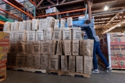 A volunteer stacks up bags of food at the Alameda Food Bank distribution center in Alameda, CA, on April 15, 2019. The food was distributed later through a drive-through to people in need following the loss of their jobs due to the “shelter-in-place” order to limit the spread of the coronavirus SARS-CoV-2.