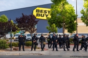 Policemen in front of the local Best Buy store in Emeryville , CA, on May 30, 2020, after it was broken into by looters.