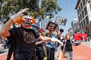 Demonstrators gather outside the Tesla dealership in San Francisco, CA, on March 29, 2025, as part of the global "Tesla Takedown" protests. These protests, spanning over 200 locations worldwide, were organized to oppose Elon Musk's involvement with the U.S. federal government and the associated budget cuts and layoffs. The protesters held signs and chanted slogans to express their discontent with Musk's actions. The movement encourages individuals to boycott Tesla products and divest from Tesla stock, aiming to impact the company's financial standing as a form of protest.