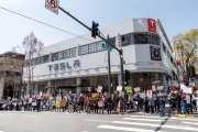 Demonstrators gather outside the Tesla dealership in San Francisco, CA, on March 29, 2025, as part of the global "Tesla Takedown" protests. These protests, spanning over 200 locations worldwide, were organized to oppose Elon Musk's involvement with the U.S. federal government and the associated budget cuts and layoffs. The protesters held signs and chanted slogans to express their discontent with Musk's actions. The movement encourages individuals to boycott Tesla products and divest from Tesla stock, aiming to impact the company's financial standing as a form of protest.