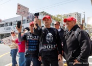 Supporters of Elon Musk's Department of Government Efficiency (DOGE) engage with demonstrators that gathered outside the Tesla dealership in San Francisco, CA, on March 29, 2025, as part of the global "Tesla Takedown" protests. These protests, spanning over 200 locations worldwide, were organized to oppose Elon Musk's involvement with the U.S. federal government and the associated budget cuts and layoffs. The protesters held signs and chanted slogans to express their discontent with Musk's actions. The movement encourages individuals to boycott Tesla products and divest from Tesla stock, aiming to impact the company's financial standing as a form of protest.