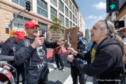 Supporters of Elon Musk's Department of Government Efficiency (DOGE) engage with demonstrators that gathered outside the Tesla dealership in San Francisco, CA, on March 29, 2025, as part of the global "Tesla Takedown" protests. These protests, spanning over 200 locations worldwide, were organized to oppose Elon Musk's involvement with the U.S. federal government and the associated budget cuts and layoffs. The protesters held signs and chanted slogans to express their discontent with Musk's actions. The movement encourages individuals to boycott Tesla products and divest from Tesla stock, aiming to impact the company's financial standing as a form of protest.