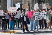 Demonstrators gather outside the Tesla dealership in San Francisco, CA, on March 29, 2025, as part of the global "Tesla Takedown" protests. These protests, spanning over 200 locations worldwide, were organized to oppose Elon Musk's involvement with the U.S. federal government and the associated budget cuts and layoffs. The protesters held signs and chanted slogans to express their discontent with Musk's actions. The movement encourages individuals to boycott Tesla products and divest from Tesla stock, aiming to impact the company's financial standing as a form of protest.