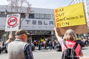 Demonstrators gather outside the Tesla dealership in San Francisco, CA, on March 29, 2025, as part of the global "Tesla Takedown" protests. These protests, spanning over 200 locations worldwide, were organized to oppose Elon Musk's involvement with the U.S. federal government and the associated budget cuts and layoffs. The protesters held signs and chanted slogans to express their discontent with Musk's actions. The movement encourages individuals to boycott Tesla products and divest from Tesla stock, aiming to impact the company's financial standing as a form of protest.