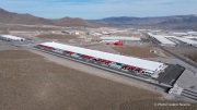 The Switch data center campus at the Tahoe Reno Industrial Center (TRIC), east of Sparks, NV, is one of the largest data center developments in the world and a defining symbol of the hyperscale infrastructure transforming northern Nevada into a major technology hub. Known for its massive, highly secure facilities, Switch built the campus to support cloud computing, enterprise data storage, and artificial intelligence workloads for large corporate clients. The company was drawn to TRIC by Nevada’s favorable tax structure, available land, access to renewable energy, and fast fiber connections to the Bay Area. The campus also uses an advanced cooling system designed for the desert climate, relying heavily on outside air and evaporative cooling technologies to reduce energy consumption while maintaining stable temperatures for thousands of servers operating around the clock. Surrounded by desert landscapes and heavy industrial development, the sprawling campus reflects the enormous physical footprint and energy demands of the digital economy powering modern internet and AI services.