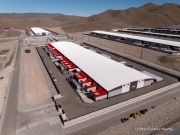 The Switch data center campus at the Tahoe Reno Industrial Center (TRIC), east of Sparks, NV, is one of the largest data center developments in the world and a defining symbol of the hyperscale infrastructure transforming northern Nevada into a major technology hub. Known for its massive, highly secure facilities, Switch built the campus to support cloud computing, enterprise data storage, and artificial intelligence workloads for large corporate clients. The company was drawn to TRIC by Nevada’s favorable tax structure, available land, access to renewable energy, and fast fiber connections to the Bay Area. The campus also uses an advanced cooling system designed for the desert climate, relying heavily on outside air and evaporative cooling technologies to reduce energy consumption while maintaining stable temperatures for thousands of servers operating around the clock. Surrounded by desert landscapes and heavy industrial development, the sprawling campus reflects the enormous physical footprint and energy demands of the digital economy powering modern internet and AI services.