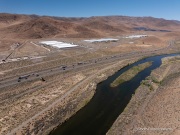The Apple Reno Data Center with the Truckee river in the foreground, in the Tahoe Reno Industrial Center (TRIC) east of Sparks, NV. 
Apple operates one of its major data center campuses there. Opened in 2012, the facility supports services such as iCloud and other online infrastructure. The site was strategically chosen for Nevada’s dry climate, which allows the servers to be cooled efficiently using outside air for much of the year. Apple has also invested heavily in renewable energy projects in the region, including large solar installations that help power the campus. 
TRIC has become an important part of Northern Nevada’s growing role as a major technology and AI infrastructure hub in the western United States.