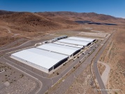 The Apple Reno Data Center with its solar panel installation in the background that is located  in the Tahoe Reno Industrial Center (TRIC) east of Sparks, NV. 
Apple operates one of its major data center campuses there. Opened in 2012, the facility supports services such as iCloud and other online infrastructure. The site was strategically chosen for Nevada’s dry climate, which allows the servers to be cooled efficiently using outside air for much of the year. Apple has also invested heavily in renewable energy projects in the region, including large solar installations that help power the campus. 
TRIC has become an important part of Northern Nevada’s growing role as a major technology and AI infrastructure hub in the western United States.