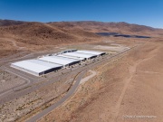 The Apple Reno Data Center with its solar panel installation in the background that is located  in the Tahoe Reno Industrial Center (TRIC) east of Sparks, NV. 
Apple operates one of its major data center campuses there. Opened in 2012, the facility supports services such as iCloud and other online infrastructure. The site was strategically chosen for Nevada’s dry climate, which allows the servers to be cooled efficiently using outside air for much of the year. Apple has also invested heavily in renewable energy projects in the region, including large solar installations that help power the campus. 
TRIC has become an important part of Northern Nevada’s growing role as a major technology and AI infrastructure hub in the western United States.