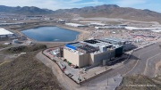 The Vantage Data Centers campus in the Tahoe Reno Industrial Center (TRIC) east of Sparks, NV, is part of the rapidly expanding hyperscale infrastructure landscape in northern Nevada, supporting large scale cloud computing and AI workloads. Like many facilities in the region, it relies on highly engineered cooling systems designed for the desert environment, combining efficient air handling with evaporative processes where water plays a measurable role in thermal management. Nearby, retention ponds and engineered water basins associated with industrial and infrastructure development in the area also reflect how water is stored, managed, and reused across large scale facilities in TRIC. The campus benefits from Nevada’s low power costs, abundant land, and strong fiber connectivity to West Coast markets, positioning it as a key node in the growing ecosystem of hyperscale data centers around Reno and Sparks.
