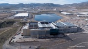 The Vantage Data Centers campus in the Tahoe Reno Industrial Center (TRIC) east of Sparks, NV, is part of the rapidly expanding hyperscale infrastructure landscape in northern Nevada, supporting large scale cloud computing and AI workloads. Like many facilities in the region, it relies on highly engineered cooling systems designed for the desert environment, combining efficient air handling with evaporative processes where water plays a measurable role in thermal management. Nearby, retention ponds and engineered water basins associated with industrial and infrastructure development in the area also reflect how water is stored, managed, and reused across large scale facilities in TRIC. The campus benefits from Nevada’s low power costs, abundant land, and strong fiber connectivity to West Coast markets, positioning it as a key node in the growing ecosystem of hyperscale data centers around Reno and Sparks.