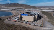 The Vantage Data Centers campus in the Tahoe Reno Industrial Center (TRIC) east of Sparks, NV, is part of the rapidly expanding hyperscale infrastructure landscape in northern Nevada, supporting large scale cloud computing and AI workloads. Like many facilities in the region, it relies on highly engineered cooling systems designed for the desert environment, combining efficient air handling with evaporative processes where water plays a measurable role in thermal management. Nearby, retention ponds and engineered water basins associated with industrial and infrastructure development in the area also reflect how water is stored, managed, and reused across large scale facilities in TRIC. The campus benefits from Nevada’s low power costs, abundant land, and strong fiber connectivity to West Coast markets, positioning it as a key node in the growing ecosystem of hyperscale data centers around Reno and Sparks.