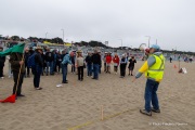 Volunteers work to lay out the design of a human banner on a beach in San Francisco on March 27, 2026. The “No Kings” protests drew thousands of people across the city as part of a nationwide day of action opposing President Donald Trump’s administration. The rallies were among thousands held across the United States, with demonstrators raising concerns about what they describe as threats to free speech, voting rights, and the war in Iran.