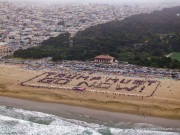 Volunteers form a human banner on a beach in San Francisco on March 27, 2026. The “No Kings” protests drew thousands of people across the city as part of a nationwide day of action opposing President Donald Trump’s administration. The rallies were among thousands held across the United States, with demonstrators raising concerns about what they describe as threats to free speech, voting rights, and the war in Iran.