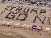 Volunteers form a human banner on a beach in San Francisco on March 27, 2026. The “No Kings” protests drew thousands of people across the city as part of a nationwide day of action opposing President Donald Trump’s administration. The rallies were among thousands held across the United States, with demonstrators raising concerns about what they describe as threats to free speech, voting rights, and the war in Iran.