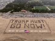 Volunteers form a human banner on a beach in San Francisco on March 27, 2026. The “No Kings” protests drew thousands of people across the city as part of a nationwide day of action opposing President Donald Trump’s administration. The rallies were among thousands held across the United States, with demonstrators raising concerns about what they describe as threats to free speech, voting rights, and the war in Iran.