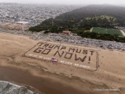 Volunteers form a human banner on a beach in San Francisco on March 27, 2026. The “No Kings” protests drew thousands of people across the city as part of a nationwide day of action opposing President Donald Trump’s administration. The rallies were among thousands held across the United States, with demonstrators raising concerns about what they describe as threats to free speech, voting rights, and the war in Iran.