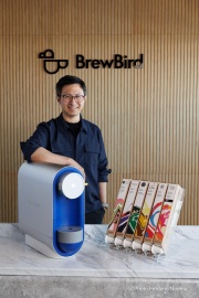 Mickey Du, founder and CEO of BrewBird, poses with his coffee brewer at the company‚Äôs headquarters in San Carlos, CA, on April 3, 2026.BrewBird is rethinking office coffee by combining whole beans in compostable pods with smart brewing technology to deliver a fresh, barista-quality cup in about a minute.