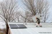 Jeem Peterson , working for GroSolar and installing new solar panels on top of Christine Bartlett's barn in South Strafford, VT, on April 7, 2010