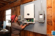 Jeem Peterson  working for GroSolar and installing new inverter at Christine Bartlett\'s barn in South Strafford, VT, on April 7, 2010