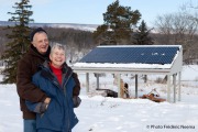 David and Gale Foulds outside their house by their shed with solar panels in Berkeley Springs.