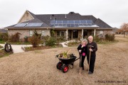 Dennis (L) and Judy Coppersmith in front of their house  in Bossier City, LA, on December 21, 2011. The 9.1kw PV system is made of 230w CSI panels, model cs6P-230P, with Enphase  Micro inverters EN-M190-72-240-S12. The first 28 panels were installed in April 2010 and 12 more in July 2011.
